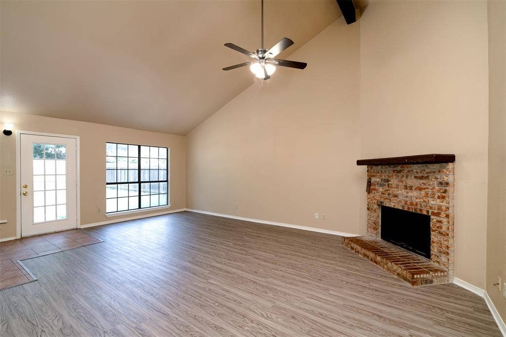 2521 Liberty Lane, Denton, TX 76209 Family room with vaulted ceiling, wood beam, lots of natural light, wood burning fireplace