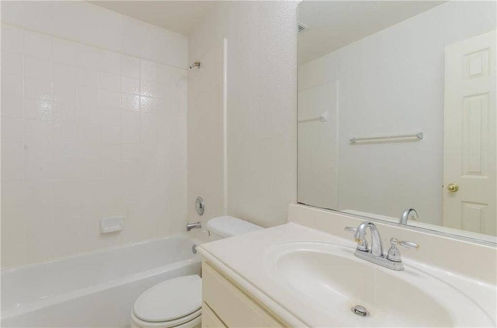 4440 Waskom Drive, Plano, TX 75024 Bathroom featuring a built-in tub and shower combination with white tile surround