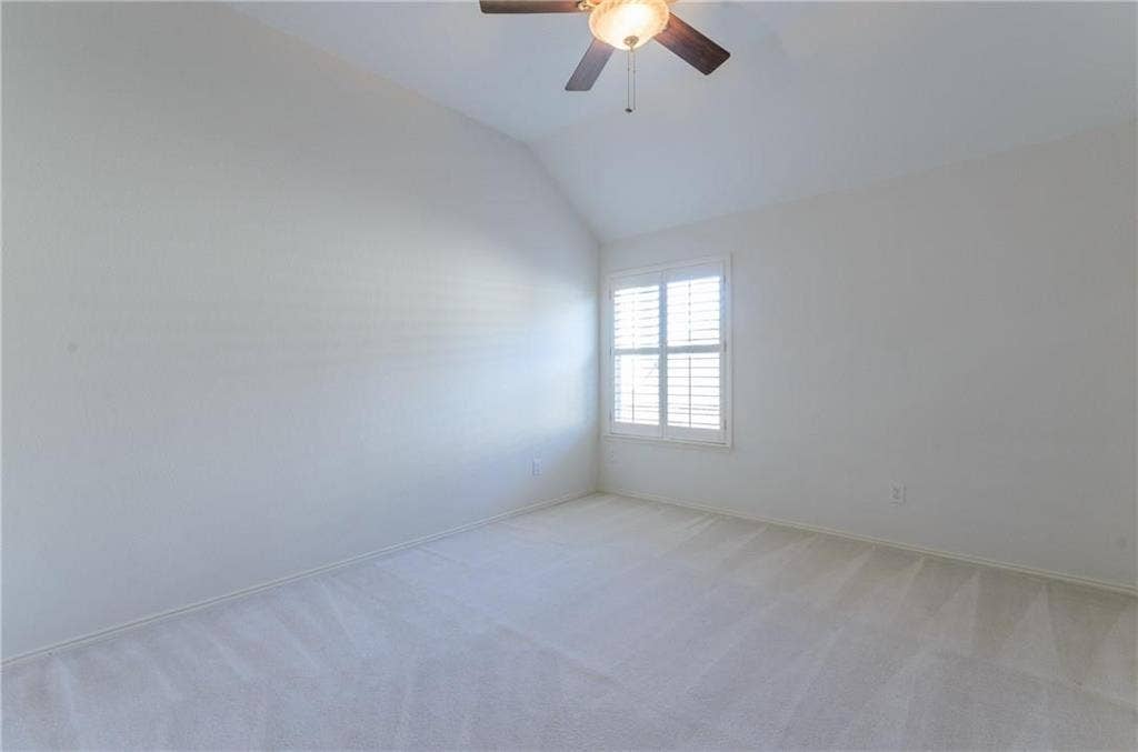 4440 Waskom Drive, Plano, TX 75024 Carpeted room featuring a vaulted ceiling and a ceiling fan with integrated lighting