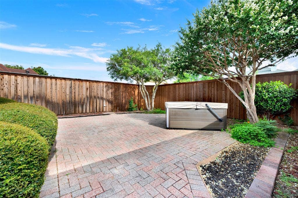 Mature, leafy trees cast cool, dancing shadows across the open courtyard space throughout the afternoon. It is an ideal setting to host a casual weekend gathering where friends can comfortably chat in the shade.