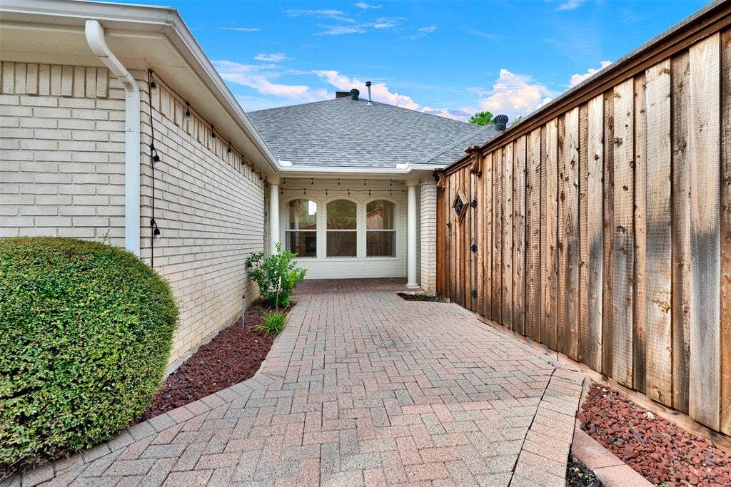 Arched windows tucked beneath the roofline add architectural depth while catching the changing colors of the sky. Plan an elegant dinner inside the dining room where the soft outdoor evening light sets a beautiful mood.
