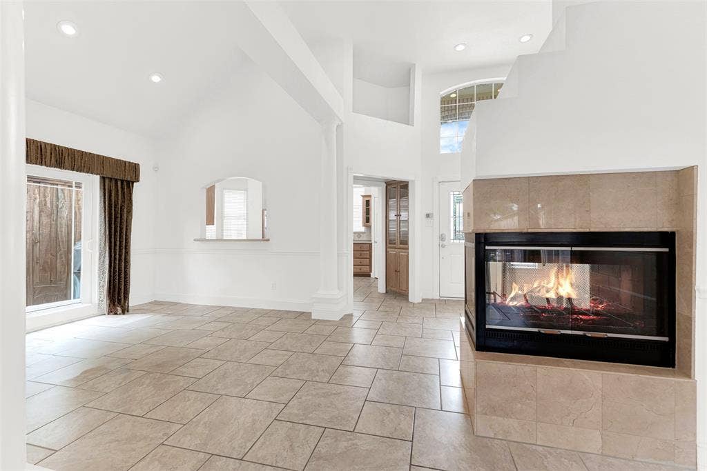 The unique, multi-sided fireplace serves as a sculptural centerpiece that warms multiple rooms simultaneously. Visualize the family gathering around the fire on a chilly winter night to share stories and laughter.