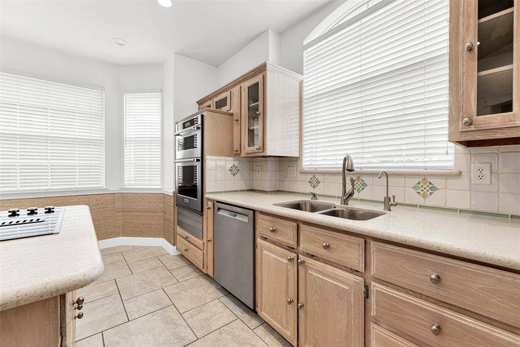 An elegant arched window sits perfectly above the dual basin sink area. Imagine prepping ingredients for an upscale weekend brunch while chatting with family.