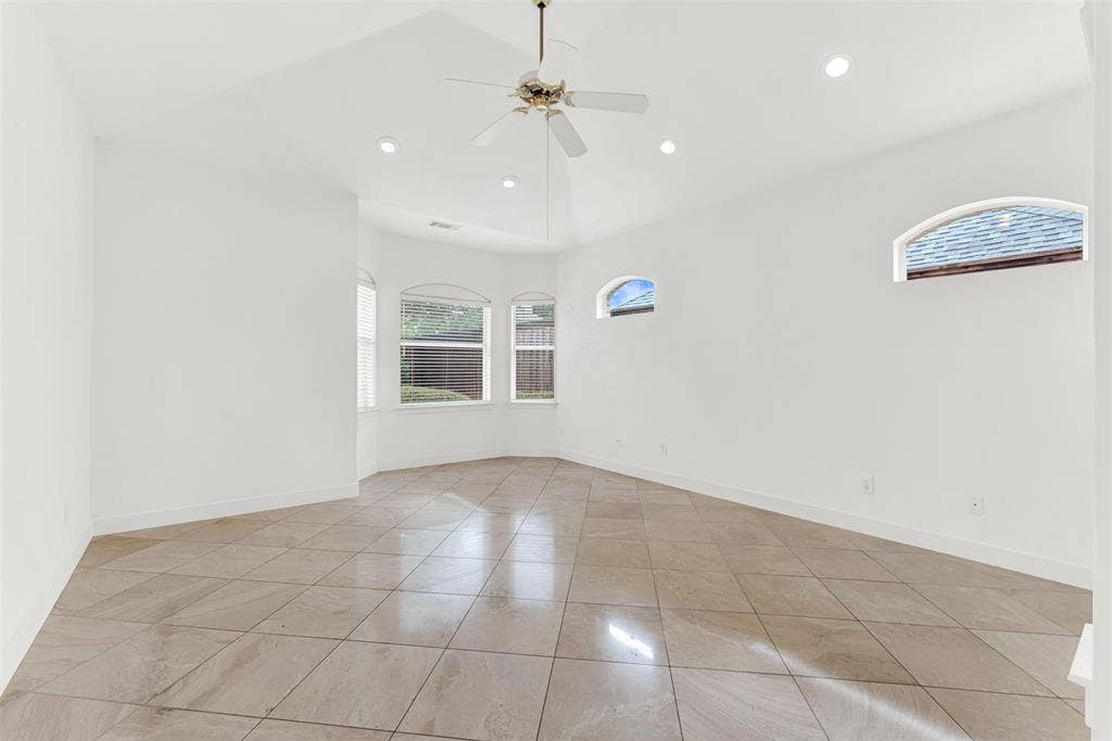 High-set, arched clerestory windows work alongside a bay alcove to wash the room in soft, balanced light. Wake up naturally as morning sunbeams slowly dance across the expansive polished tile floor.