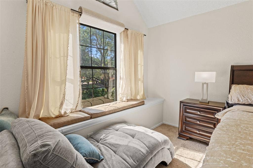 Window seating with cushioned pads and a large window featuring multi-pane detailing