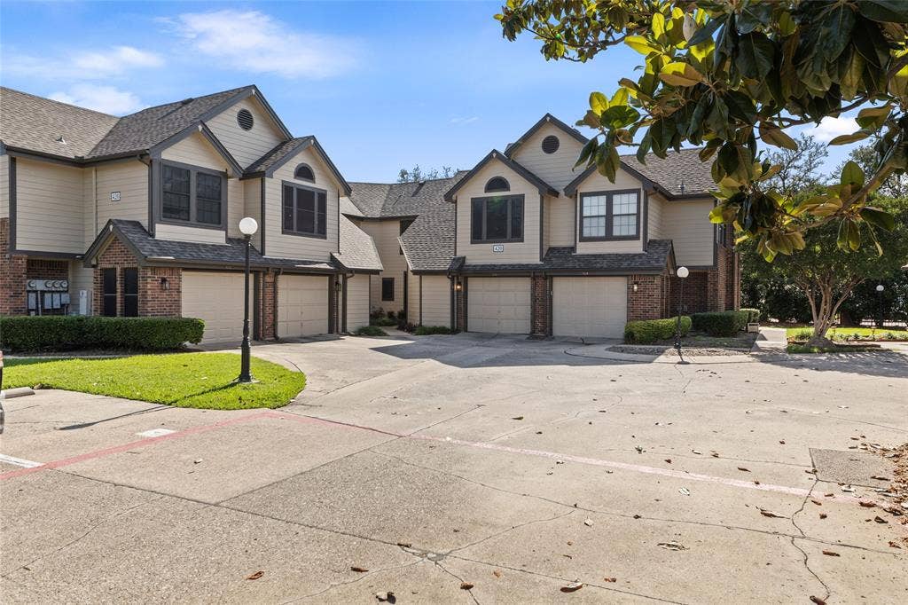 Multi-level townhome exterior featuring brick and siding finishes