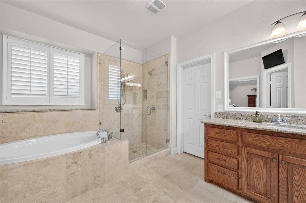 Large primary bath with garden tub and lovely frameless shower!