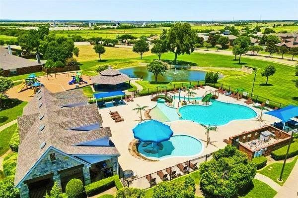 414 Dartmoor Drive, Celina, TX 75009 The neighborhood community pool in Carter Ranch at 414 Dartmoor Dr in Celina, Texas. This resident-only amenity area features a large swimming pool, splash pad, poolside seating, and covered cabanas, providing a resort-style outdoor experience for homeowners in the Carter Ranch subdivision.