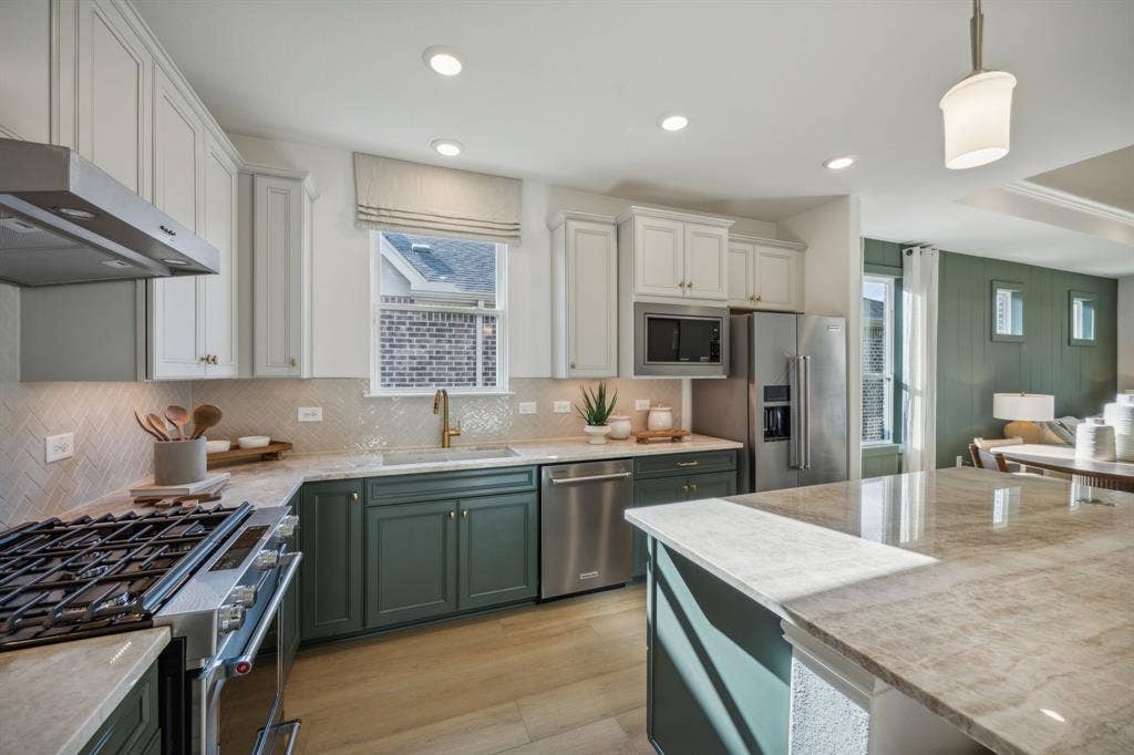 305 Snowbird Way, McKinney, TX 75071 *Model Representation - Large island overlooking gathering room and dining areas