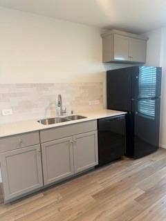 2402 Hesperus Avenue, Crandall, TX 75114 Contemporary kitchen area featuring light gray cabinetry, a double basin stainless steel sink, black appliances, and wood-finish flooring