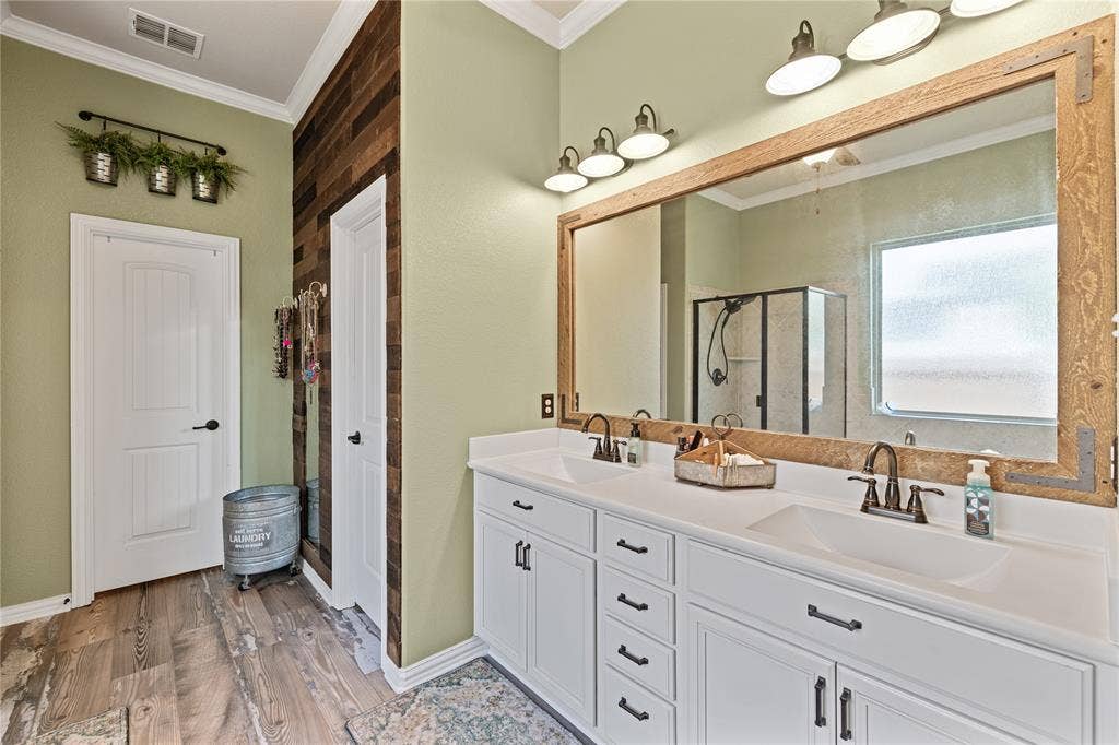 12012 Tobosa Circle, McKinney, TX 75071 Bathroom featuring ornamental molding, walk in shower, hardwood / wood-style flooring, and dual vanity