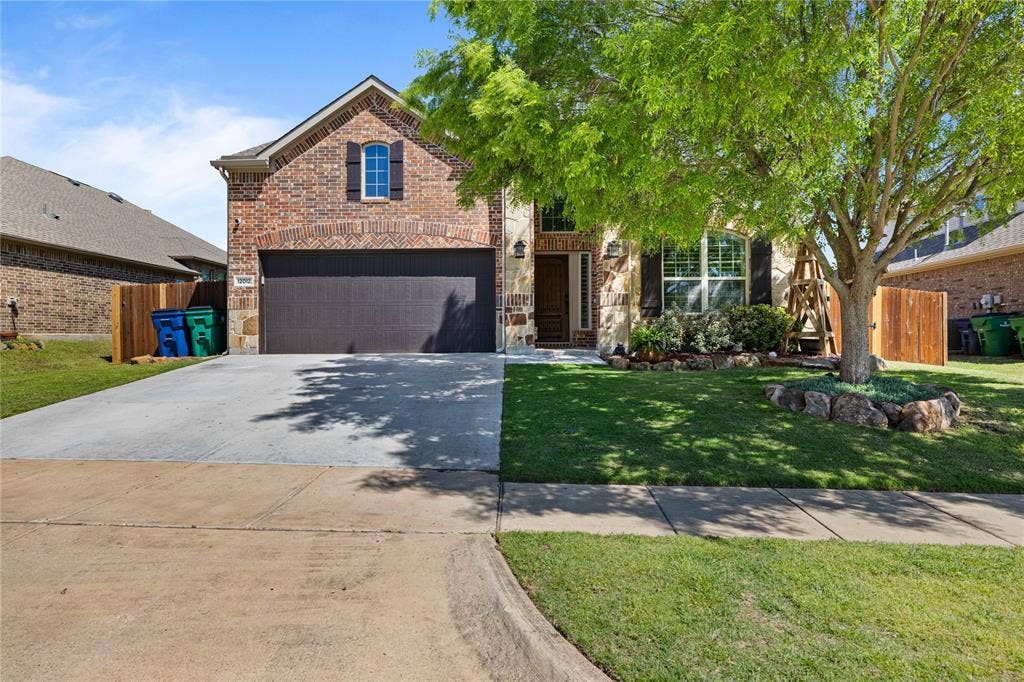 12012 Tobosa Circle, McKinney, TX 75071 View of front facade with a garage and a front lawn