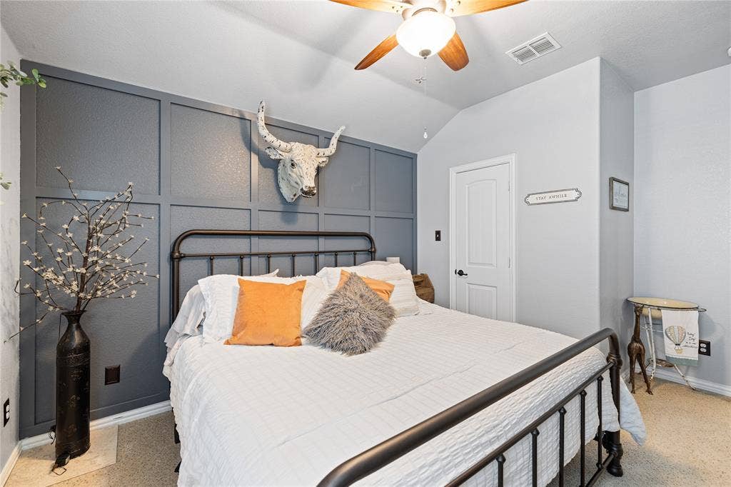 12012 Tobosa Circle, McKinney, TX 75071 Bedroom featuring light colored carpet, lofted ceiling, and ceiling fan