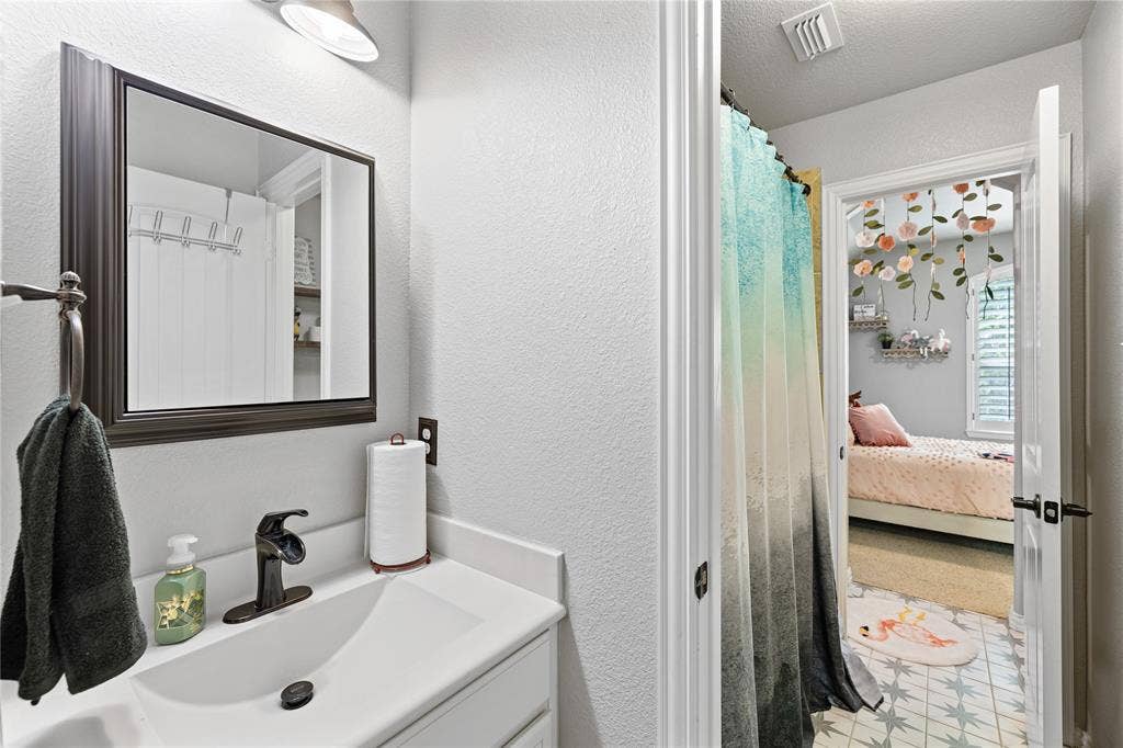 12012 Tobosa Circle, McKinney, TX 75071 Bathroom featuring tile flooring, vanity, and a textured ceiling