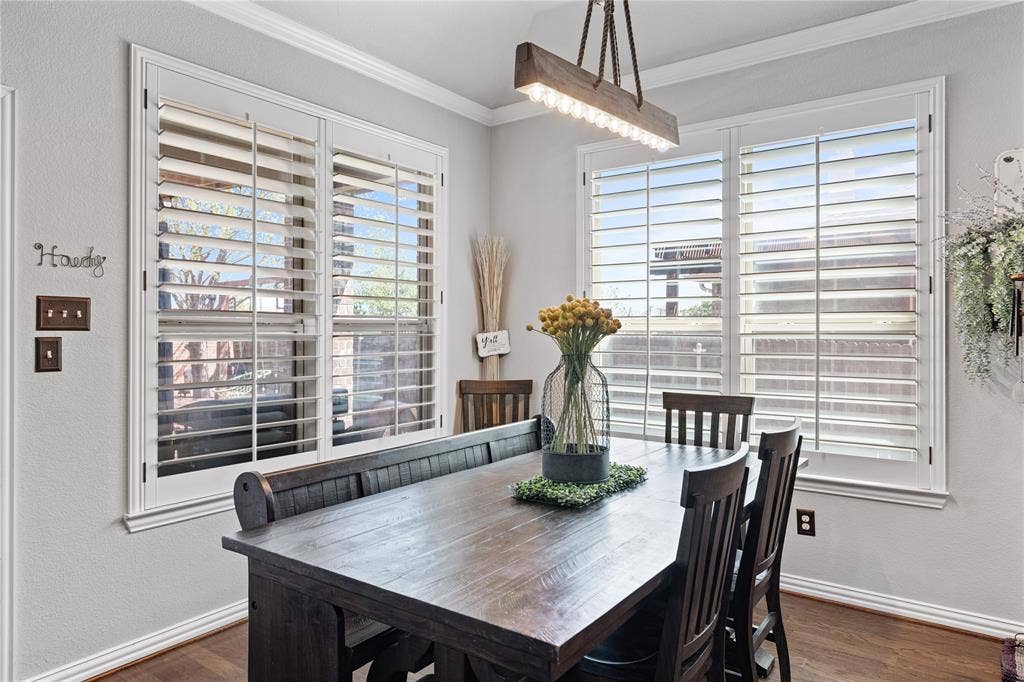 12012 Tobosa Circle, McKinney, TX 75071 Dining space with a wealth of natural light, ornamental molding, and dark hardwood / wood-style flooring