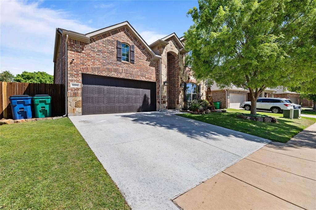 12012 Tobosa Circle, McKinney, TX 75071 View of front of property featuring a front lawn and a garage