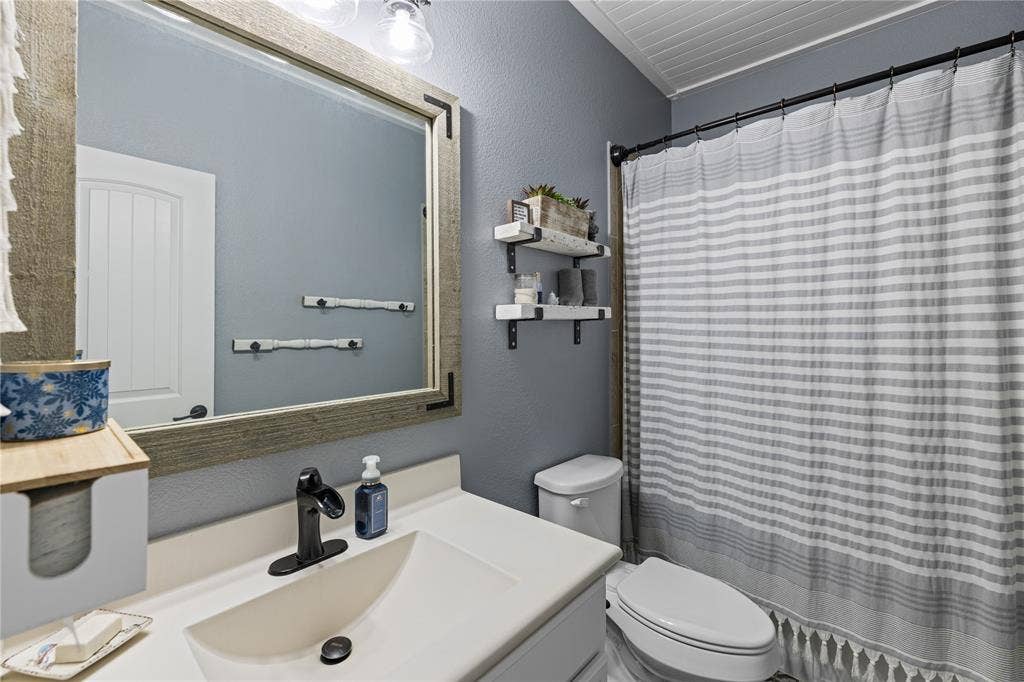 12012 Tobosa Circle, McKinney, TX 75071 Bathroom featuring vanity and toilet