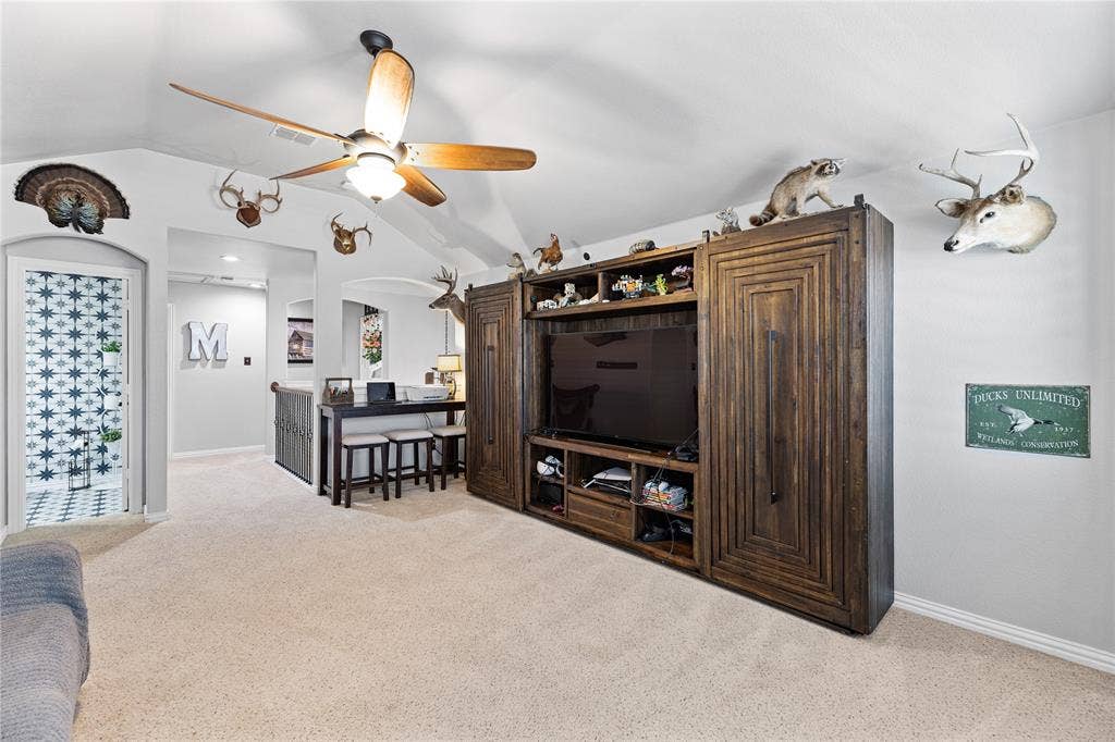 12012 Tobosa Circle, McKinney, TX 75071 Living room with light carpet, ceiling fan, and lofted ceiling