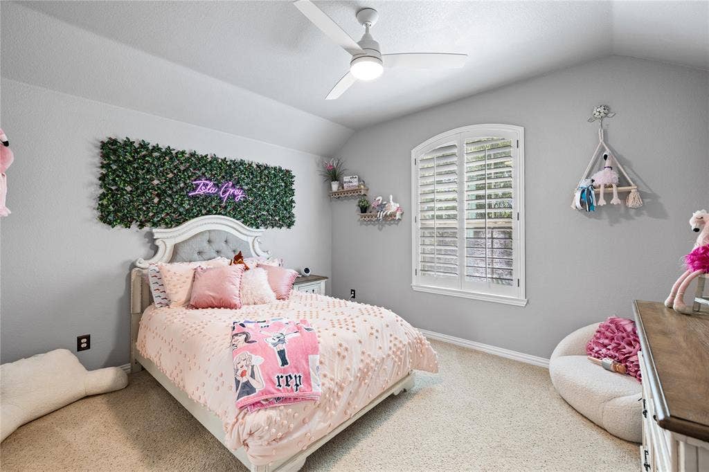 12012 Tobosa Circle, McKinney, TX 75071 Bedroom featuring light carpet, ceiling fan, and lofted ceiling