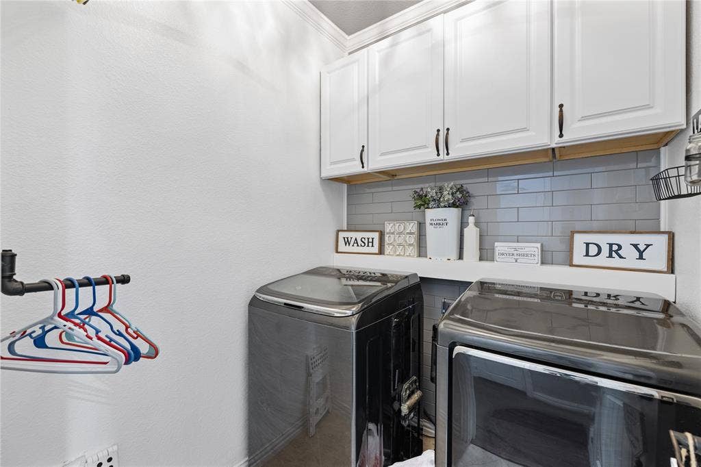 12012 Tobosa Circle, McKinney, TX 75071 Laundry room with cabinets and washer and clothes dryer