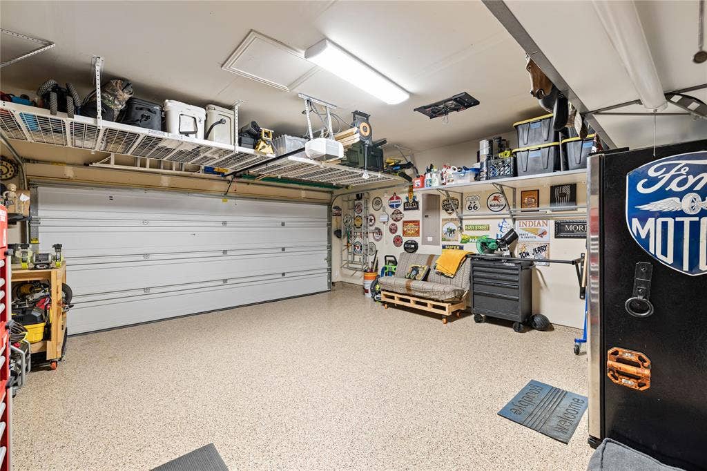 12012 Tobosa Circle, McKinney, TX 75071 Garage with a workshop area and a garage door opener