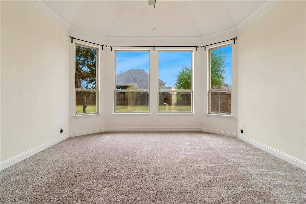 1650 Chisholm Trail, Prosper, TX 75078 Bay window with five individual windows, carpeted flooring, white baseboards, and crown molding