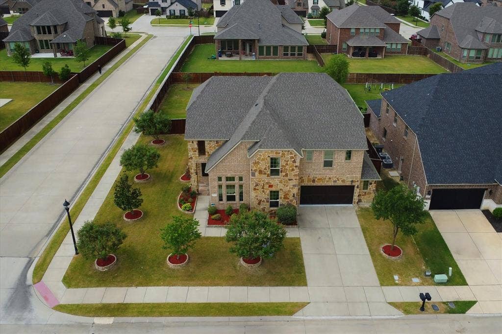 1650 Chisholm Trail, Prosper, TX 75078 Stone and brick facade with a prominent two-car garage