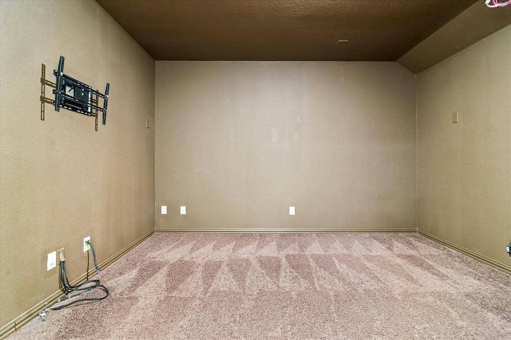 1650 Chisholm Trail, Prosper, TX 75078 Room featuring patterned carpet, light brown wall finish, and a dark brown ceiling