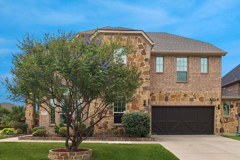 1650 Chisholm Trail, Prosper, TX 75078 Two-story residence featuring a brick and stone facade