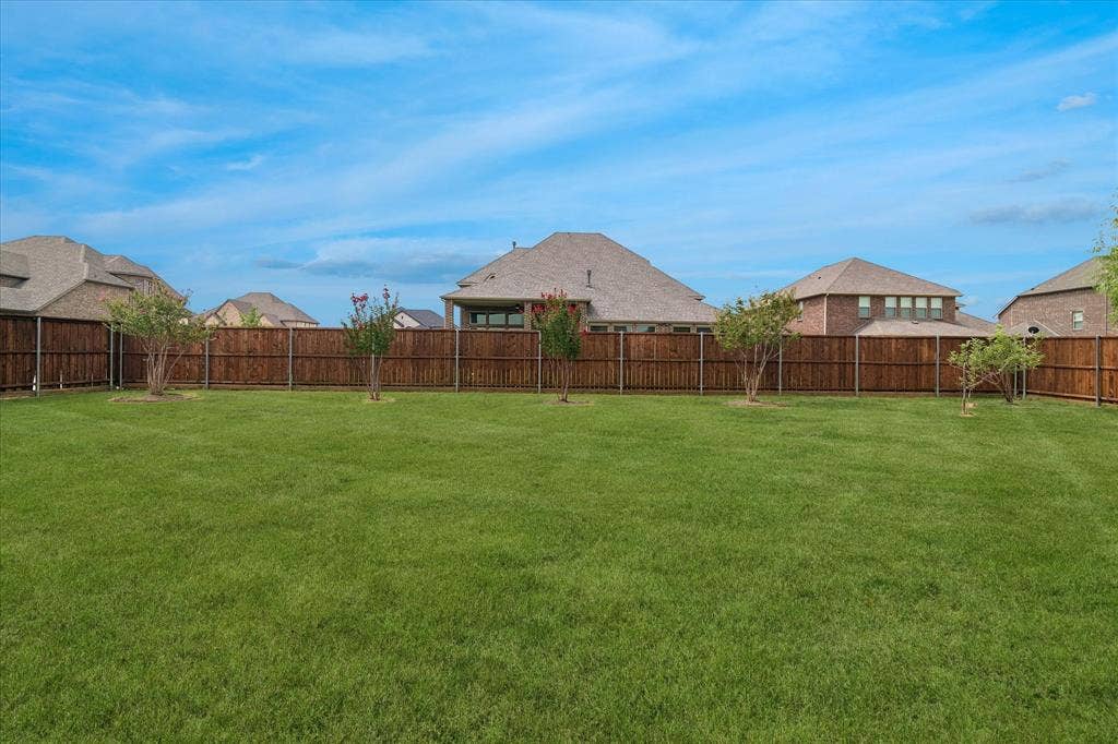1650 Chisholm Trail, Prosper, TX 75078 Expansive backyard featuring a lush green lawn