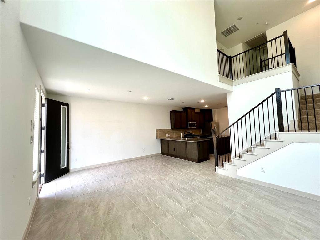 1755 Montgomery Drive, Plano, TX 75075 Unfurnished living room featuring a towering ceiling