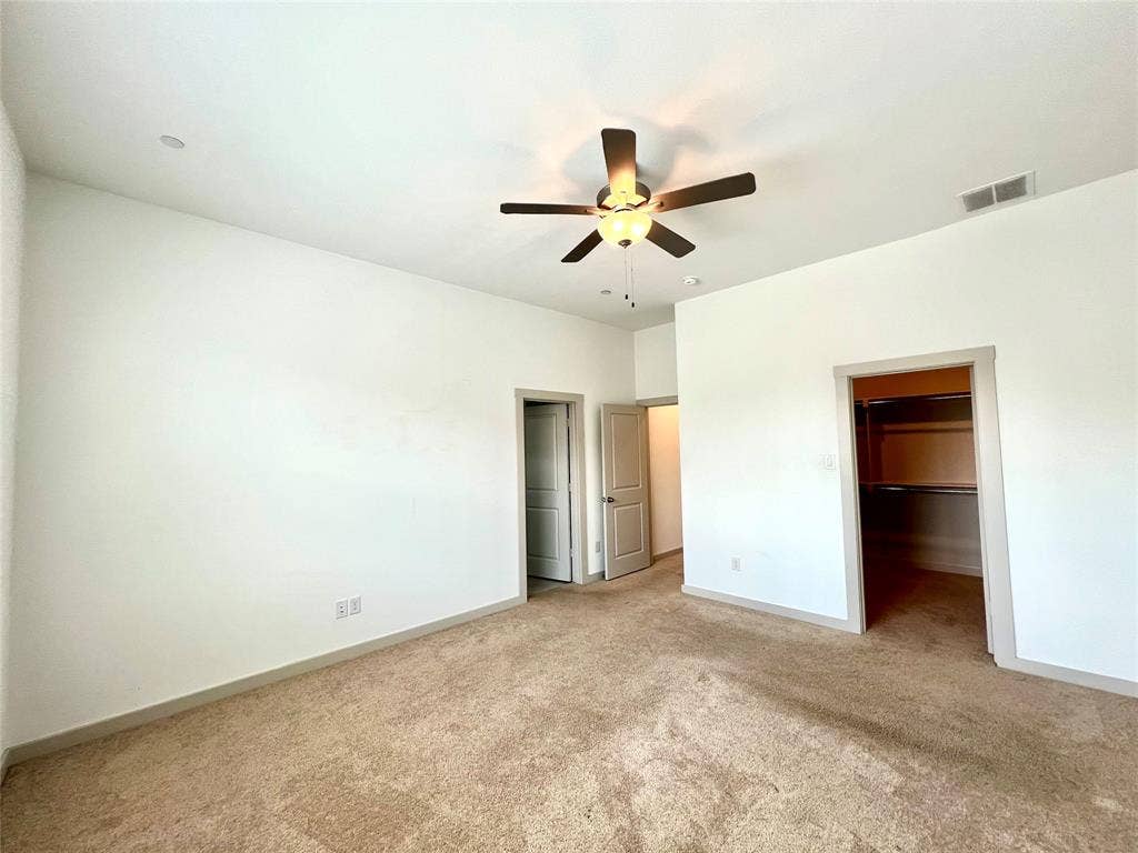 1755 Montgomery Drive, Plano, TX 75075 Unfurnished bedroom featuring light colored carpet, a spacious closet, ceiling fan, and a closet