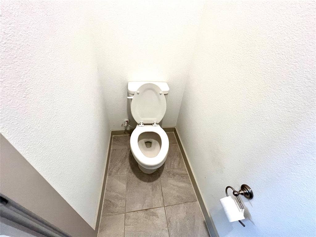 1755 Montgomery Drive, Plano, TX 75075 Bathroom featuring tile patterned flooring and toilet