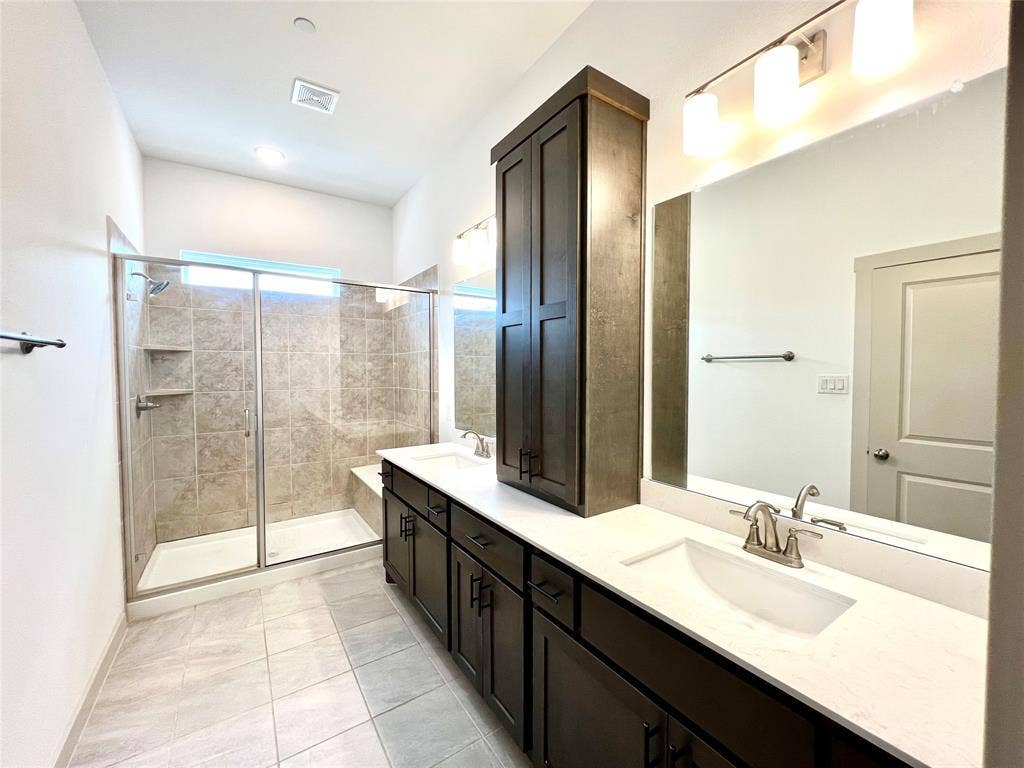 1755 Montgomery Drive, Plano, TX 75075 Bathroom featuring tile patterned flooring, an enclosed shower, and vanity