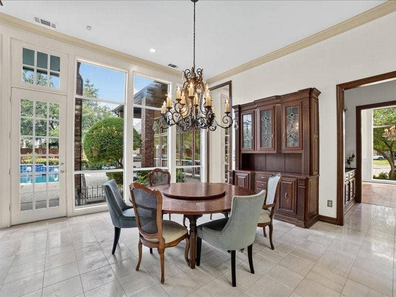 5201 Windjammer Road, Plano, TX 75093 Dining area featuring extensive windows and a full-light glass panel door, providing views of the pool area