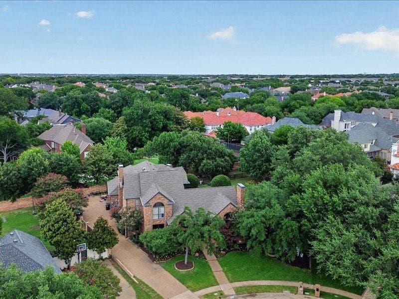 5201 Windjammer Road, Plano, TX 75093 .55 acre of private property with a stone and brick exterior, multi-gabled roofline, and arched window details