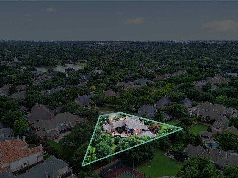 5201 Windjammer Road, Plano, TX 75093 Aerial perspective of a brick residence with a gabled roofline, featuring a swimming pool and mature landscaping