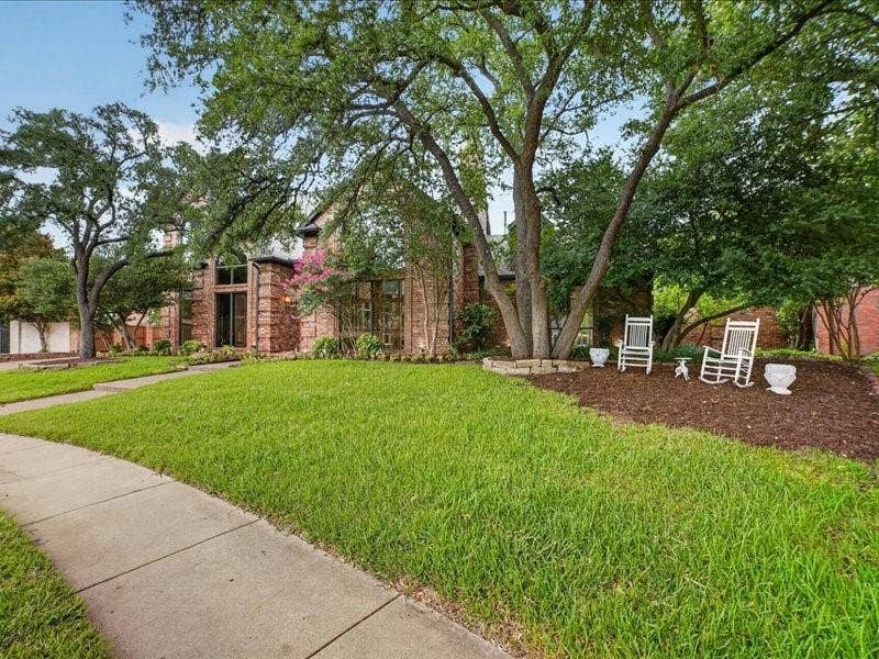 5201 Windjammer Road, Plano, TX 75093 Brick facade residence with a prominent arched window and a manicured lawn