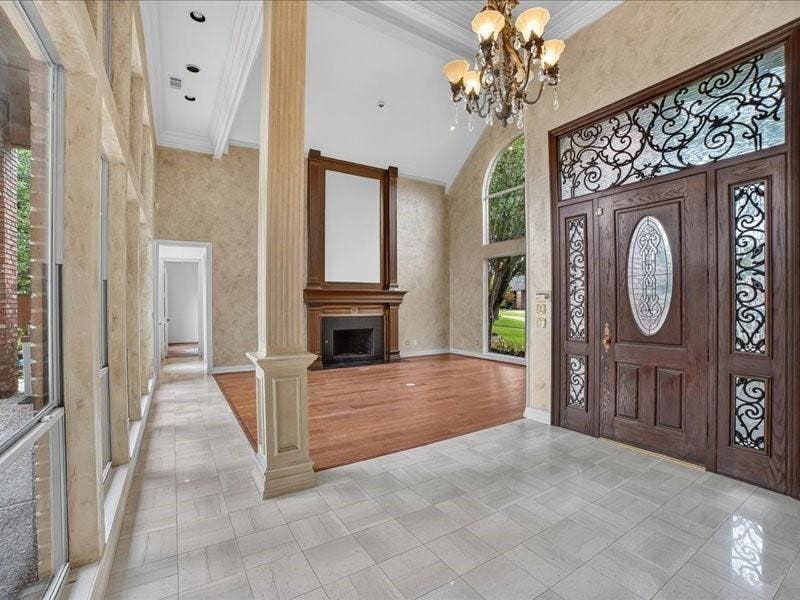 5201 Windjammer Road, Plano, TX 75093 Grand entry featuring a double wood front door with decorative ironwork and leaded glass accents