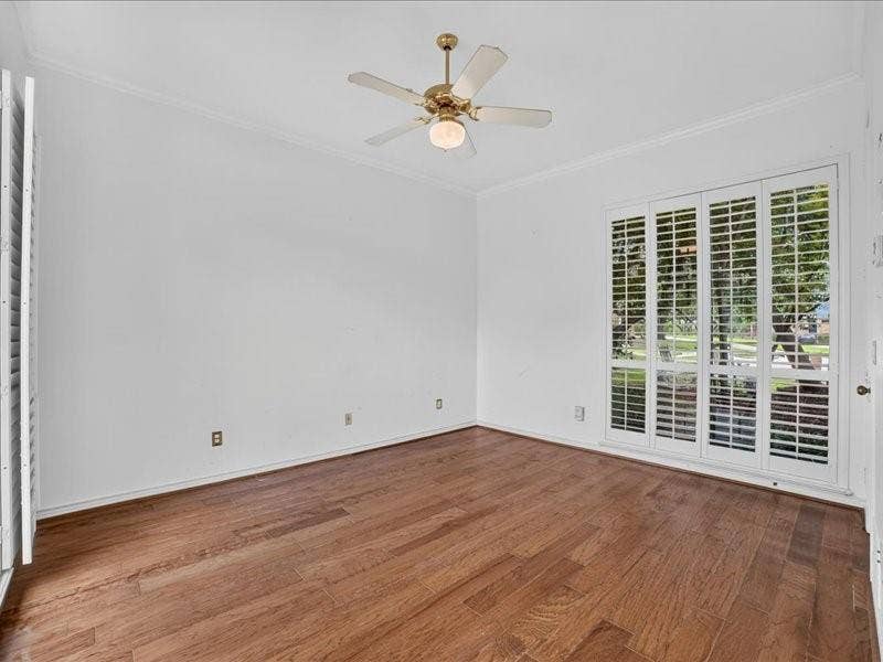 5201 Windjammer Road, Plano, TX 75093 Spacious room Primary another view featuring wood-finish fflooring, white walls, and crown molding