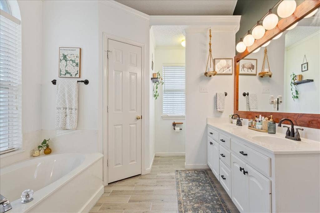 10308 Eagle Mountain Drive, Waco, TX 76712 Dual vanity with white cabinetry and dark hardware