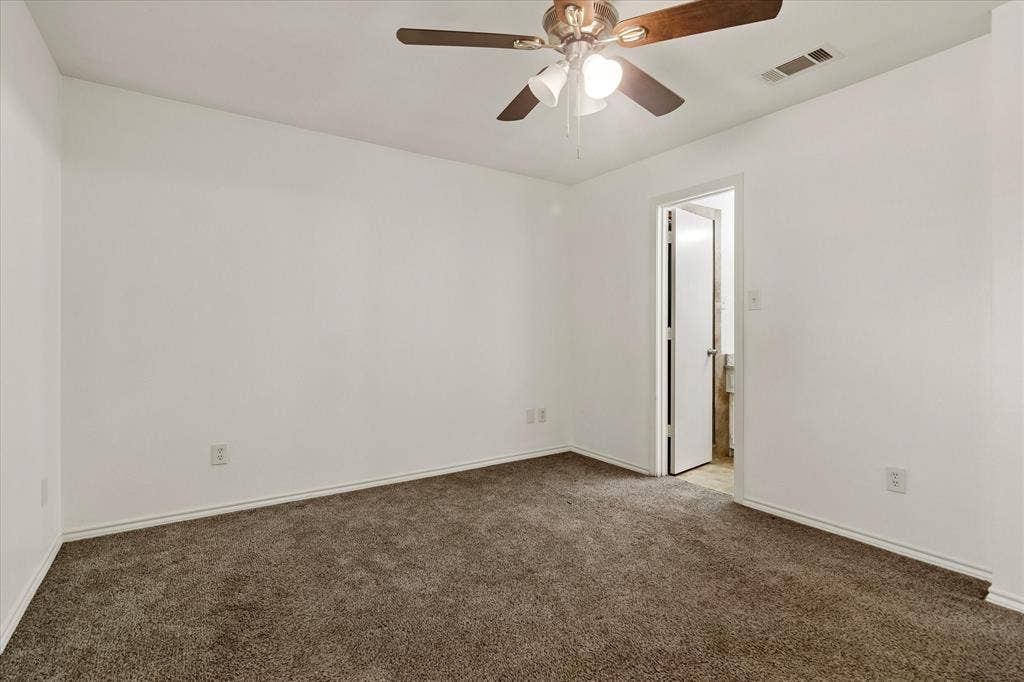 3318 Wells Drive, Plano, TX 75093 Carpeted room with a ceiling fan, white walls, and white baseboards