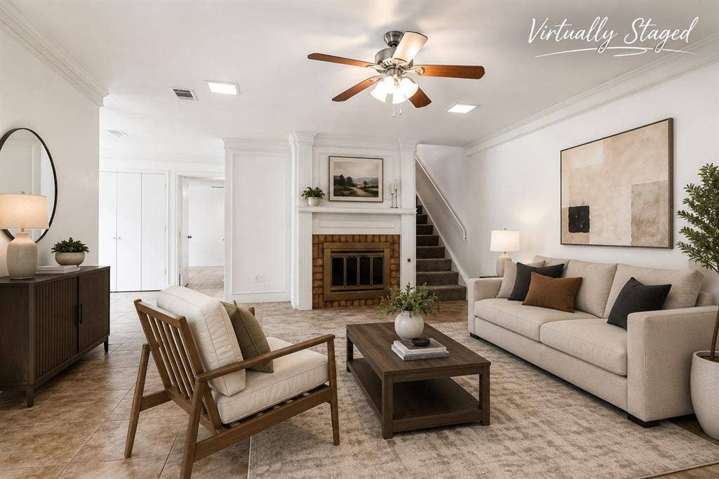 3318 Wells Drive, Plano, TX 75093 Living area featuring a white wood mantel fireplace with a brick surround, a staircase with carpeted treads, and a ceiling fan with light fixture