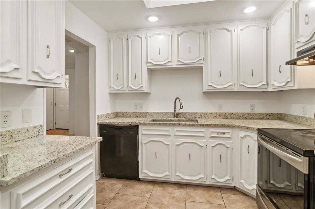 3318 Wells Drive, Plano, TX 75093 Kitchen featuring white cabinetry, speckled countertops, stainless steel sink with gooseneck faucet, black dishwasher, and tile flooring