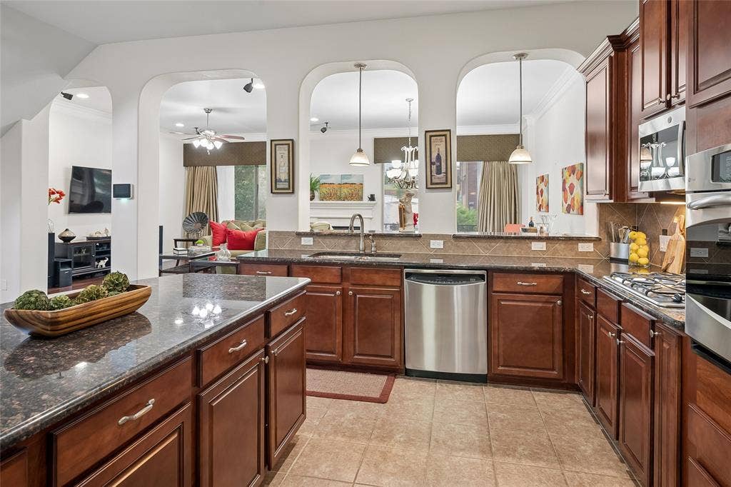 Stainless appliances and a center island are in the well-appointed kitchen.