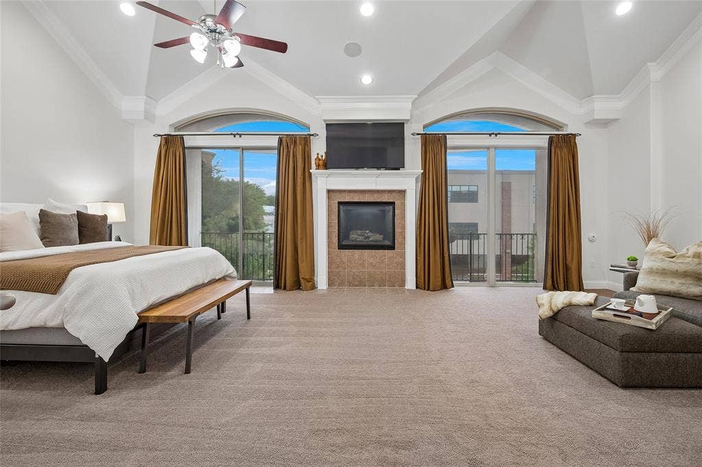 High ceilings with crown molding and two balconies are in the primary suite.