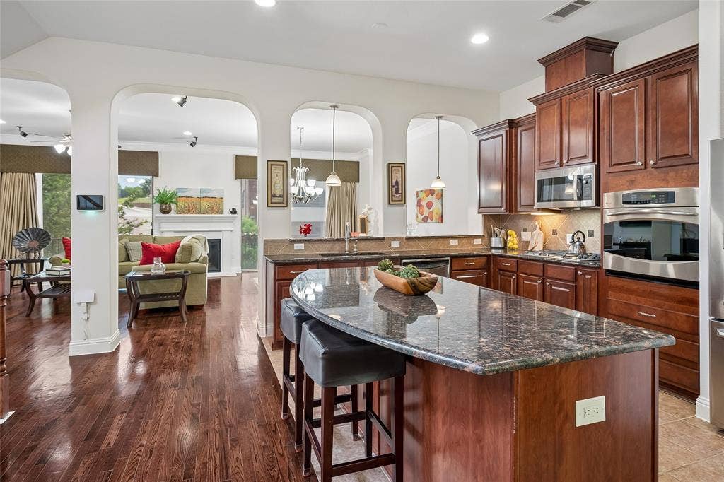Archways accent the open kitchen to the living and dining rooms.