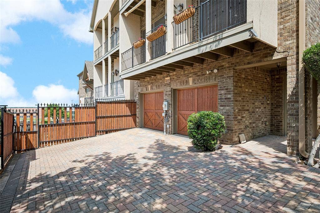 Driveway to garage extends to a spacious patio.