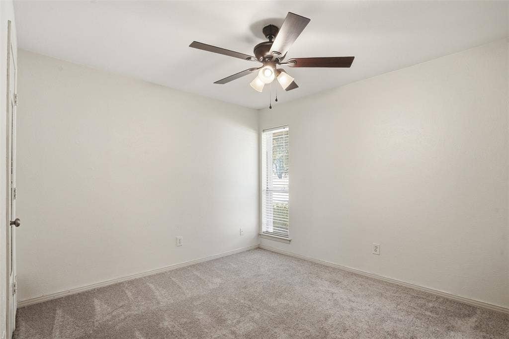 1000 Lexington Drive, Plano, TX 75075 Carpeted room with a ceiling fan light fixture, light-colored walls, and a window with blinds