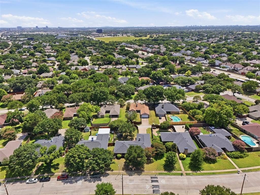 1000 Lexington Drive, Plano, TX 75075 Expansive residential area featuring numerous single-family homes, mature tree coverage, and private swimming pools